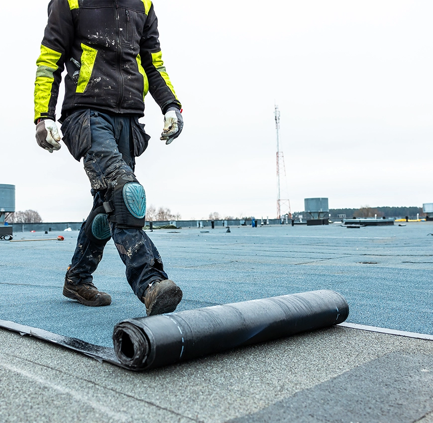 Professional commercial roofing installation featuring a flat roof membrane system designed for long-lasting waterproofing, durability, and weather resistance.