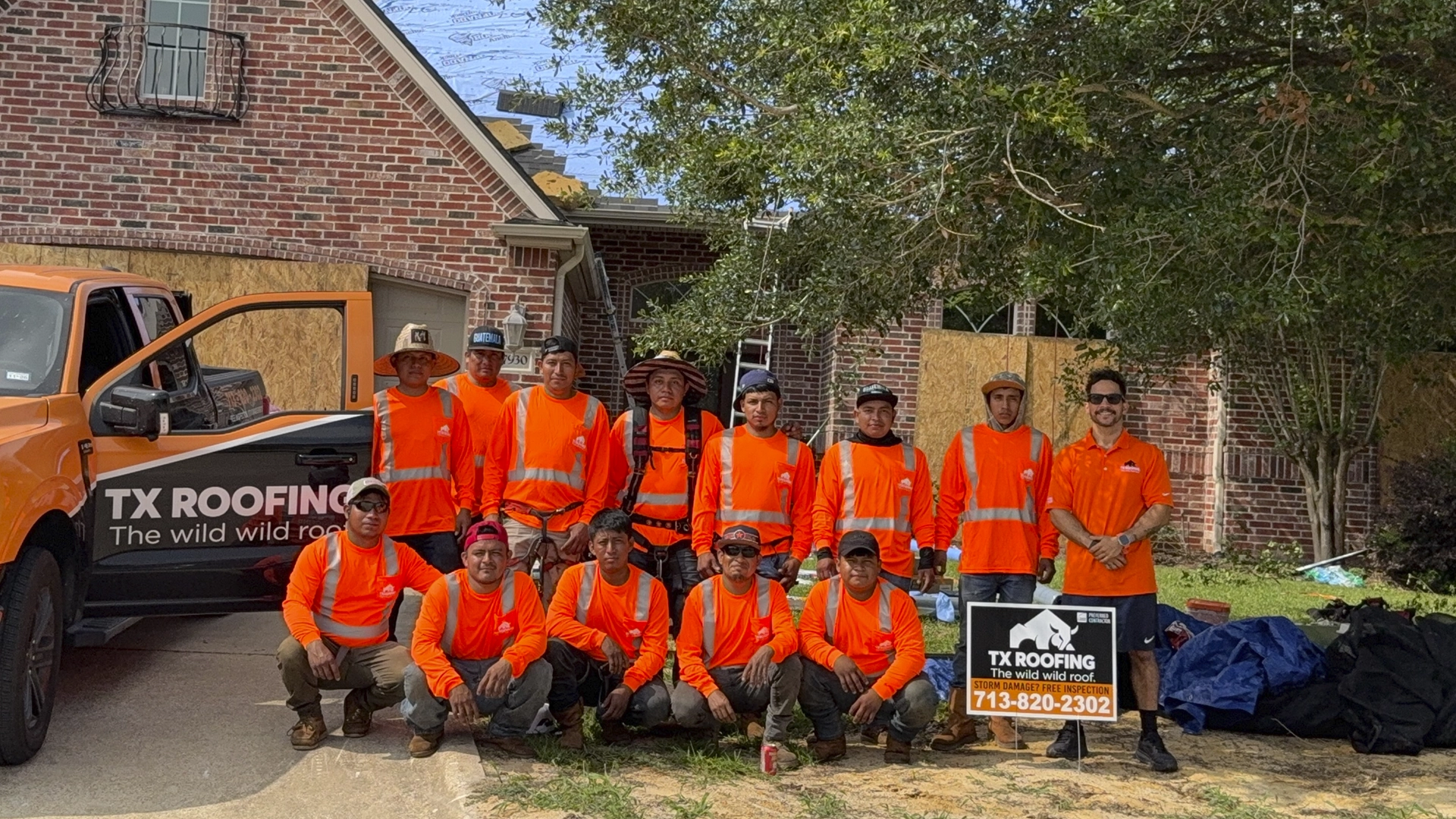 TX Roofing & Services roofing crew posing in front of a residential roof replacement project in the Greater Houston area.